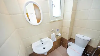a bathroom with a white toilet and a sink at Kapparis Holiday Villa 018 in Protaras