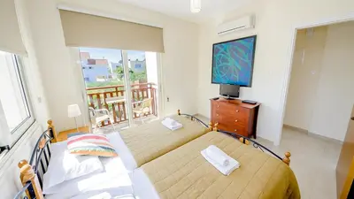 a bedroom with a bed and a television on a dresser at Kapparis Holiday Villa 018 in Protaras