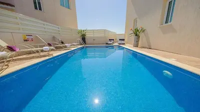 a large blue swimming pool in a building at Pernera Holiday Villa 012 in Protaras