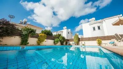 a swimming pool in front of a building at Ayia Napa Holiday Villa 003 in Ayia Napa