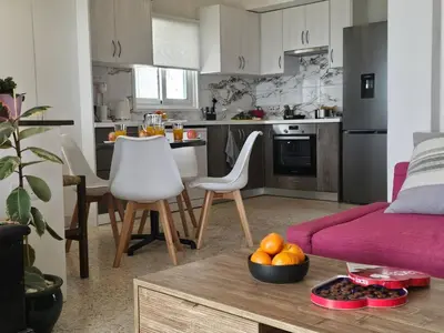 a living room with a couch and a table at Ammos Beachfront Villa Paradise in Larnaka