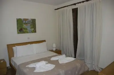 a bedroom with a bed with towels on it at Summer Breeze in Paralimni