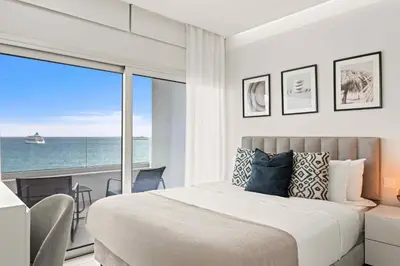 a bedroom with a bed and a view of the ocean at Phaedrus Living: Limassol Seaside Residences 01 in Limassol