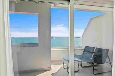 a balcony with a view of the ocean and a chair at Phaedrus Living: Limassol Seaside Residences 02 in Limassol