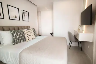 a white bedroom with a bed and a desk at Phaedrus Living: Limassol Seaside Residences 03 in Limassol