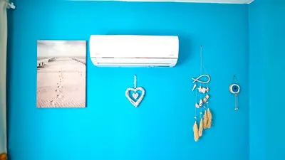 a room with a blue wall with photographs and pins at 2Br Apt Coastal Comfort with Internet Access in Larnaka