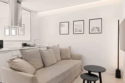 a white living room with a couch and a table at Phaedrus Living Limassol Seaside Residences 06 in Limassol