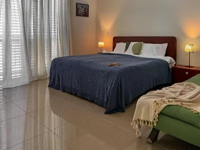 a bedroom with a bed with a blue comforter at Villa Marina in Ayia Thekla with Heated Pool in Ayia Napa