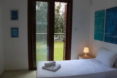 a bedroom with a bed with two towels on it at The Olive Tree in Protaras