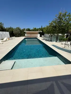 a swimming pool in the middle of a house at The Olive Tree in Protaras
