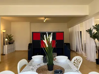 a dining room with a table with white chairs at STUDIO in Limassol