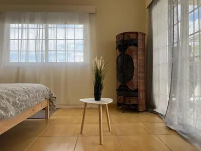 a bedroom with a bed and a table and a window at STUDIO in Limassol