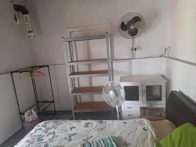 a bedroom with a ladder and a bed and a fan at Room with private entrance from outside, traditional house in Livadhia