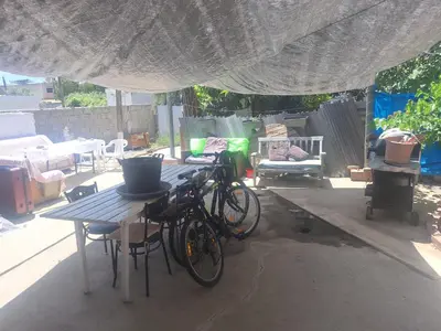 two bikes parked at a table under a tent at Room with private entrance from outside, traditional house in Livadhia