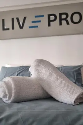 a towel sitting on top of a bed at LivePro in Larnaka
