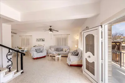 a living room with a couch and a table at Ayia Thekla Sea Breeze Villa in Ayia Napa