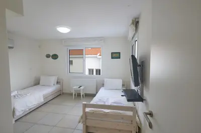 a room with two beds and a window at Protaras Serifos Villa Sv07 in Paralimni