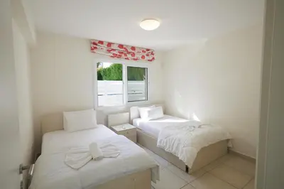 a small room with two beds and a window at Protaras Serifos Villa Sv07 in Paralimni