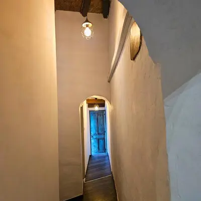 a hallway with a blue door in a building at Traditional adobe house in Evrychou with cozy garden and fireplace! in Nicosia