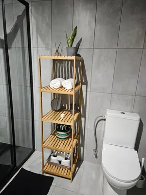 a bathroom with a wooden shelf next to a toilet at Traditional adobe house in Evrychou with cozy garden and fireplace! in Nicosia