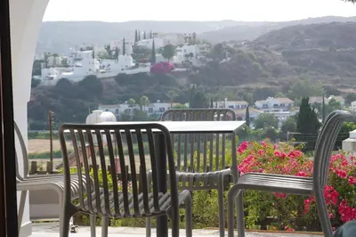 a group of chairs and a table with flowers at Skeleas Apartments in Pissouri