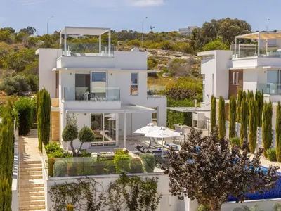 a large white house with trees in front of it at Villa Natalie-Mylos H24 in Protaras