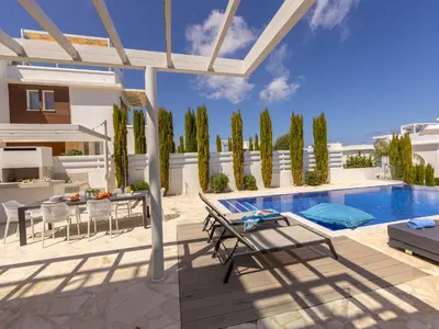 a villa with a swimming pool and a patio at Villa Natalie-Mylos H24 in Protaras