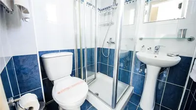 a blue and white bathroom with a toilet and a sink at Protaras Holiday Villa 045 in Protaras