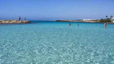 a group of people swimming in the ocean at Ayia Napa Holiday Villa 036 in Ayia Napa