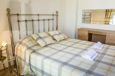 a bedroom with a large bed with towels on it at Protaras Holiday Villa 035 in Protaras