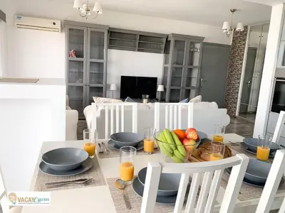 a dining room with a table with a bowl of fruit at Downtown Larnaca Apartment in Larnaka