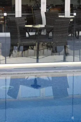 a reflection of a table and chairs in a window at Livadia Hotel Kyperounta in Kyperounda