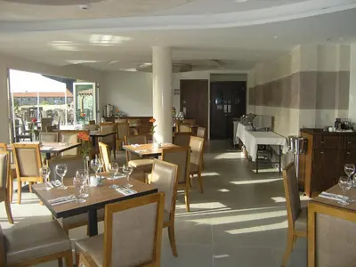 a restaurant with tables and chairs and a piano at Livadia Hotel Kyperounta in Kyperounda