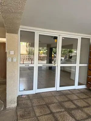 a building with sliding glass doors in a building at Marethea rooms in Larnaka