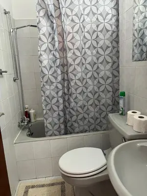 a bathroom with a shower with a toilet and a sink at Marethea rooms in Larnaka