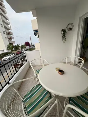a white table and chairs on a balcony at Marethea rooms in Larnaka