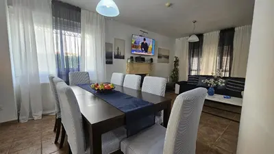 a dining room with a table and white chairs at STAY Princess Villa in Protaras