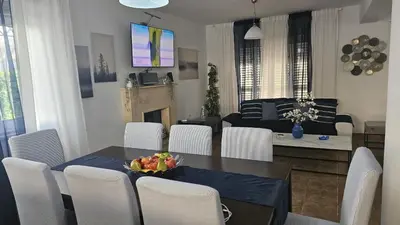 a dining room and living room with a table and chairs at STAY Princess Villa in Protaras