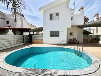 a swimming pool in front of a house at STAY Princess Villa in Protaras