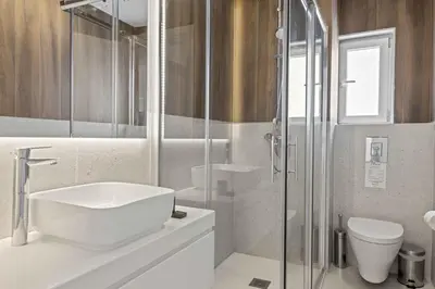 a bathroom with a sink and a toilet and a shower at Phaedrus Living: Limassol Seaside Residences 05 in Limassol