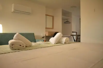 a hotel room with a bed with towels on it at Green Bay Suites in Protaras