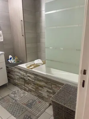 a bathroom with a bath tub and a sink at Quattro City Center Apartments in Larnaka