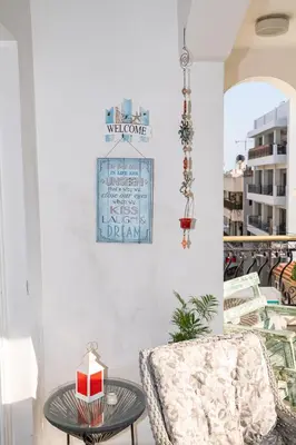 a living room with a chair and a table at Quattro City Center Apartments in Larnaka