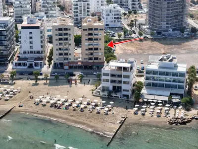 an aerial view of a beach with umbrellas and buildings at Luxury Stay at Mackenzie Beach with Private Parking and Balcony in Larnaka