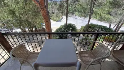 a white table and chairs on a balcony at Calming Mountain View Apt with Balcony & Free Parking near Kakopetria in Nicosia