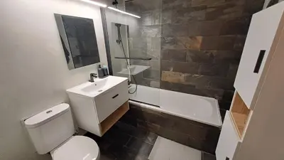 a bathroom with a toilet and a sink and a tub at Calming Mountain View Apt with Balcony & Free Parking near Kakopetria in Nicosia