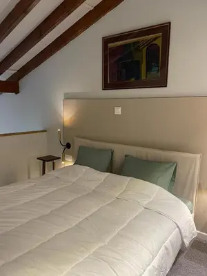a bedroom with a large white bed in a room at Calming Mountain View Apt with Balcony & Free Parking near Kakopetria in Nicosia