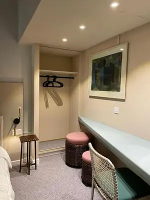 a room with a bed and a table and stool at Calming Mountain View Apt with Balcony & Free Parking near Kakopetria in Nicosia