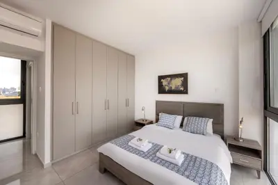 a bedroom with a large bed with two towels at Villa Pliades in Ayia Napa