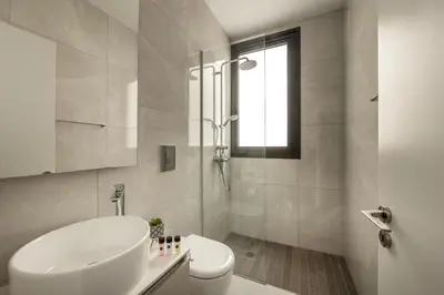 a bathroom with a sink and a toilet and a shower at Villa Pliades in Ayia Napa